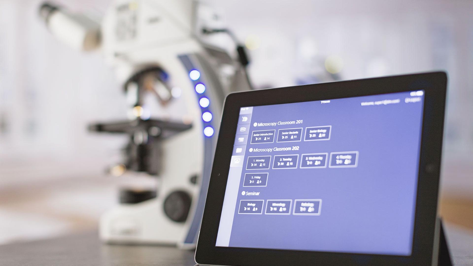 ZEISS Labscope classroom software running on a tablet, sitting on top of a table next to a ZEISS Primostar microscope