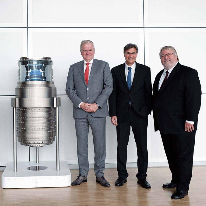 Anniversary celebration with management marking 50 years of ZEISS SMT - photographed in front of lithography optics