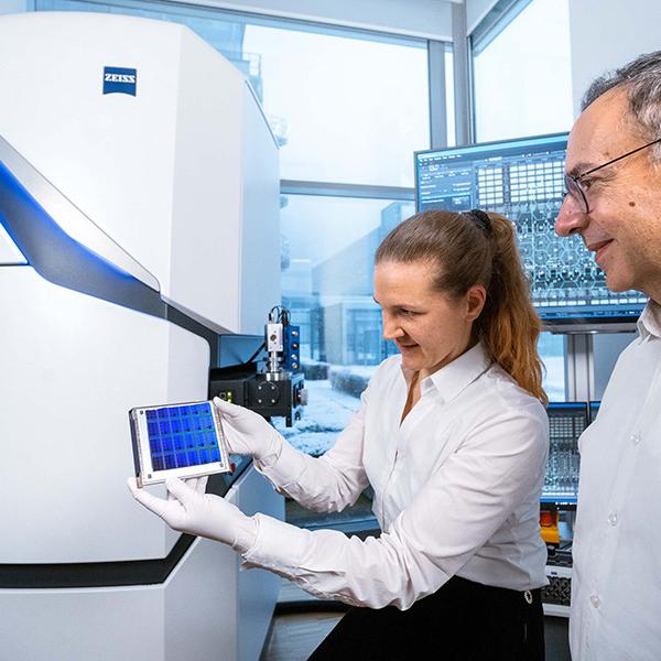 Two employees work on the MultiSEM