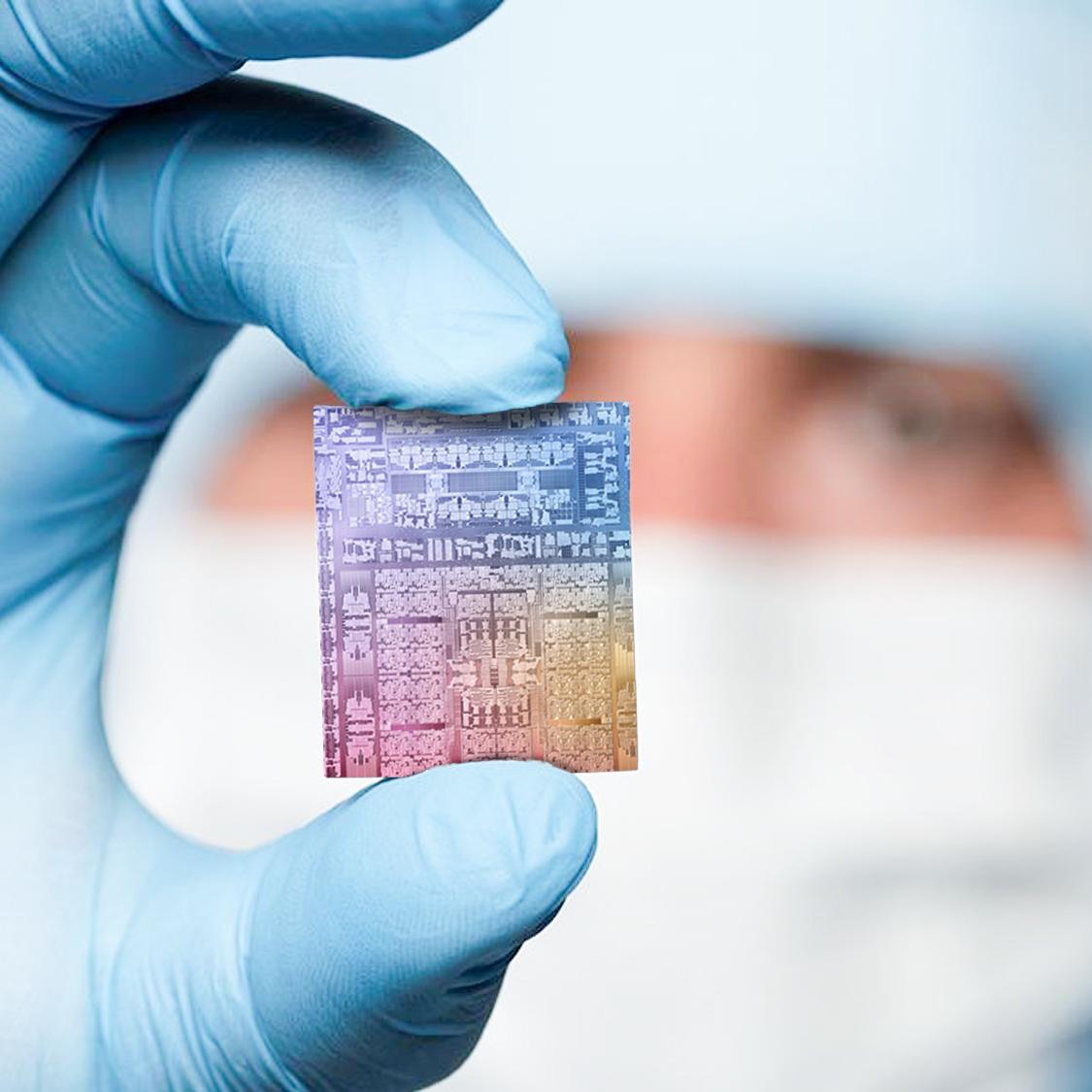 One hand holds a microchip made with EUV technology between its fingers