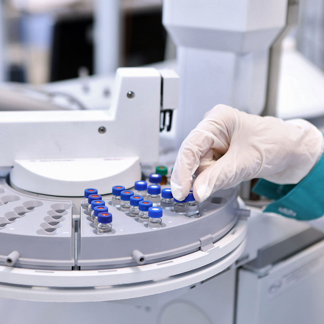 Quality Control Laboratory medicine. High Pressure Liquid Chromatography operation. A woman makes an analysis on a gas chromatograph.