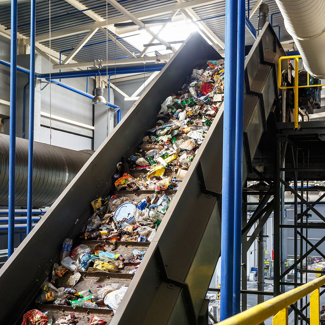 Moving conveyor transporter on modern waste automated recycling processing plant. Separate and sorting garbage collection. Recycling and storage of waste for further disposal.