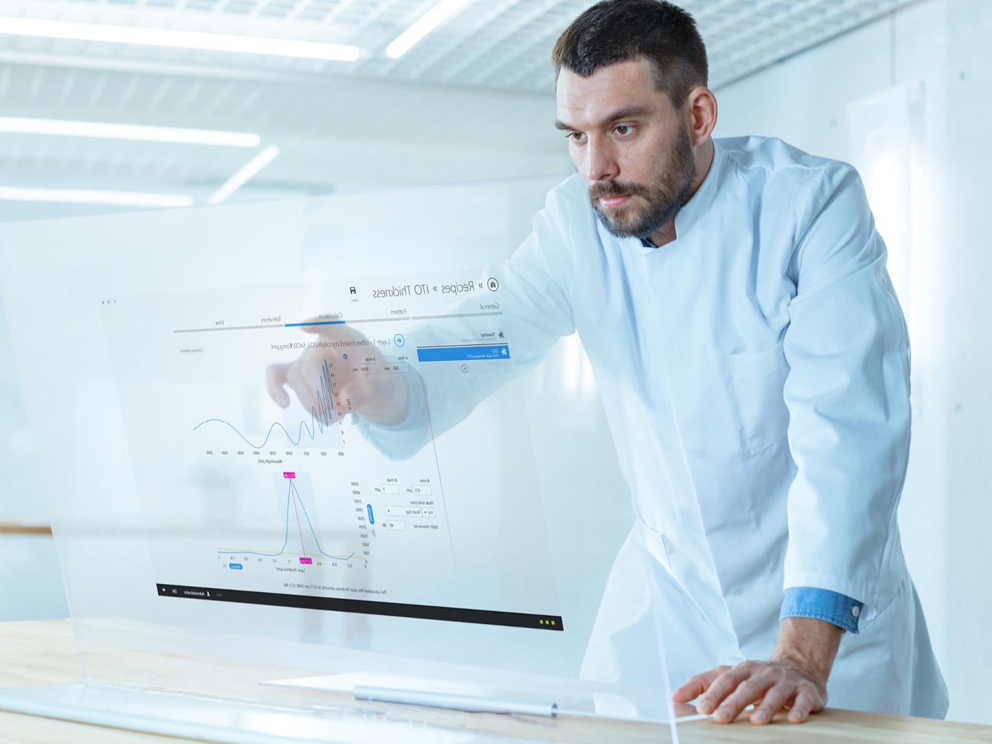 Futuristic Laboratory Male Scientist Works on His Transparent Computer Display, ThinProcess Software on screen, batch processing applications