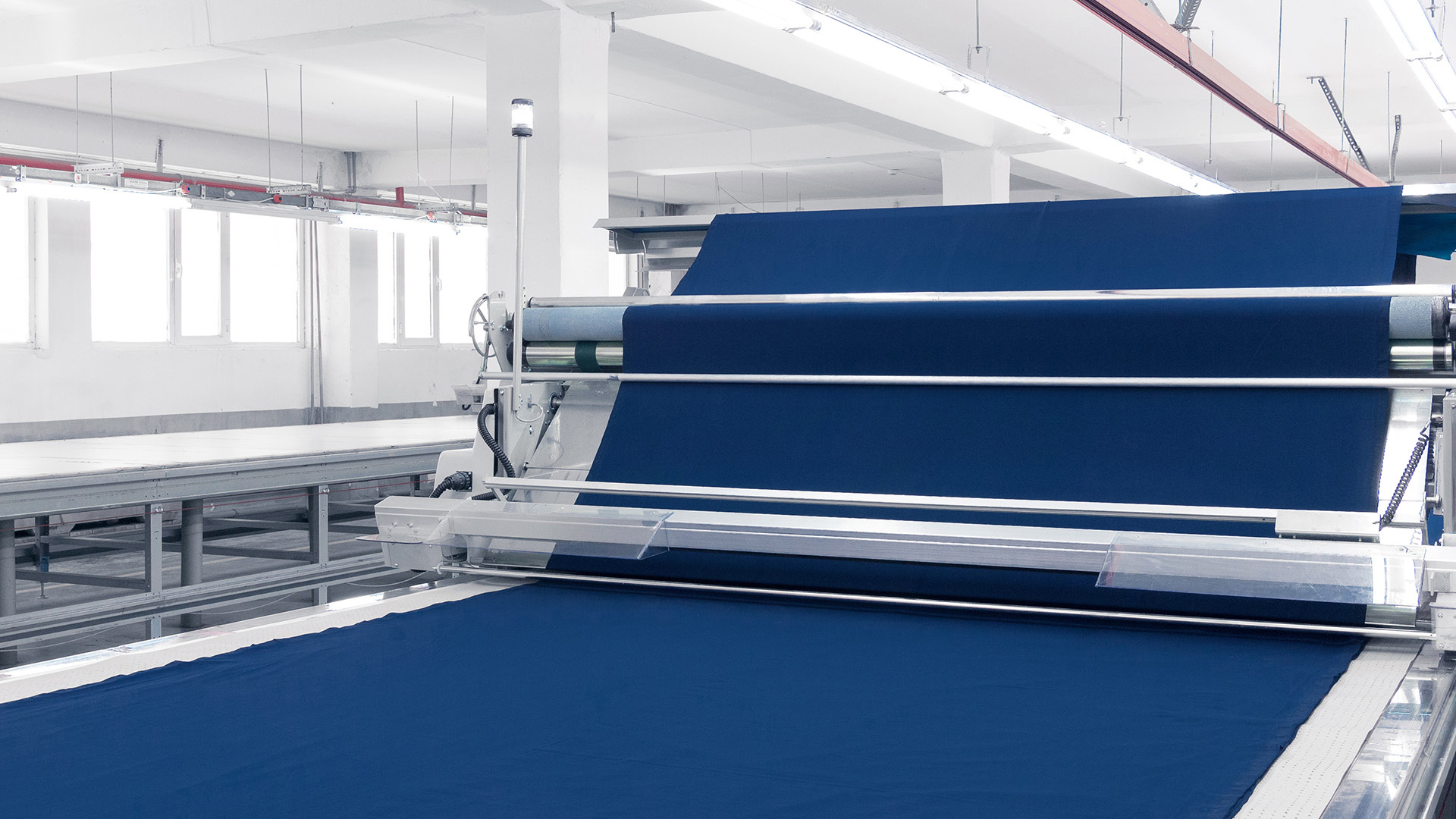 coated textile runs over large rolls in a textile factory