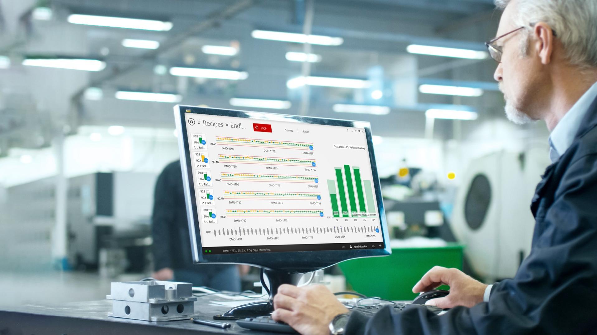 engineer sits in front of the computer in a production environment in his office, the screen show the interface of the thinprocess software 