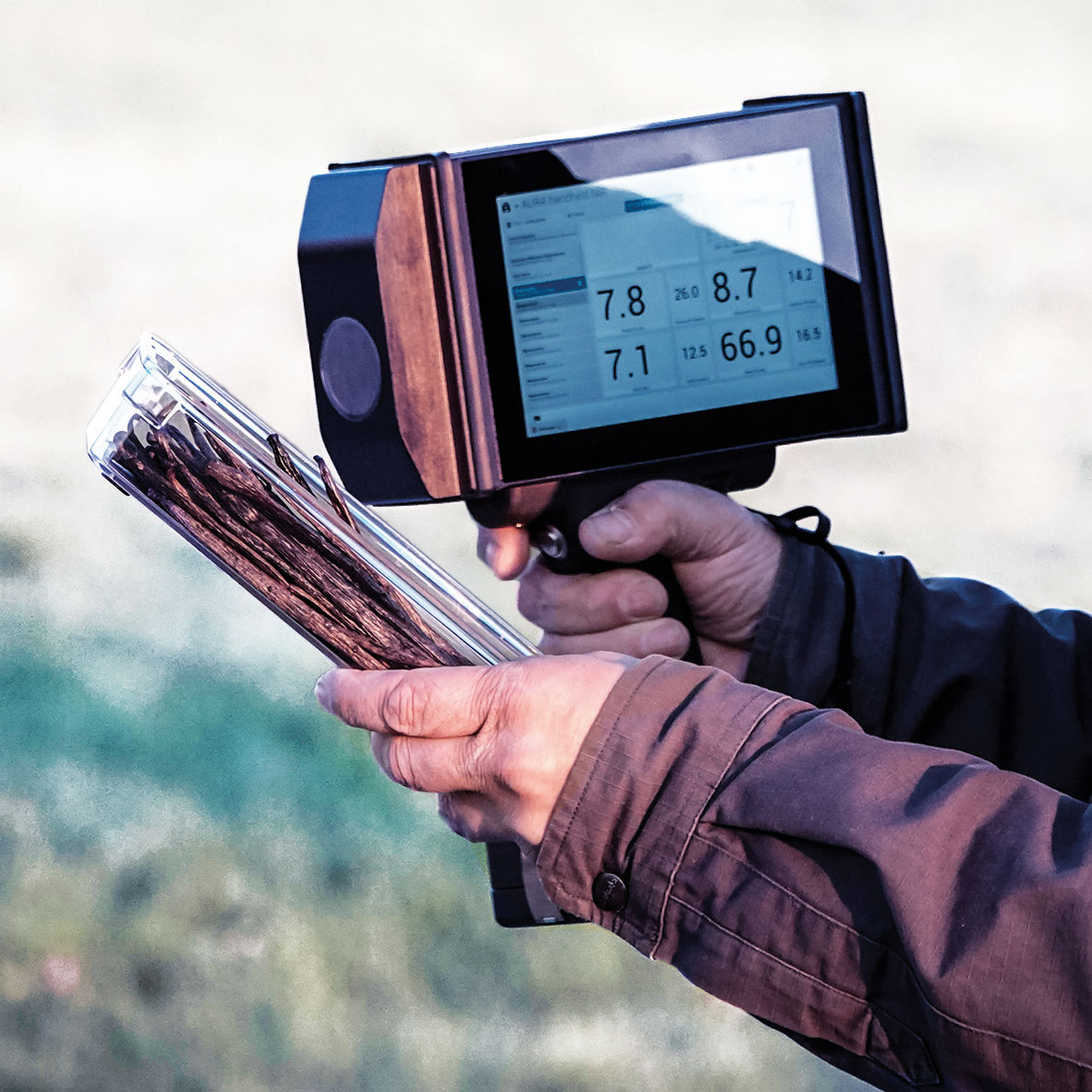 Man holds AURA® handheld NIR and measures the sample directly in the field