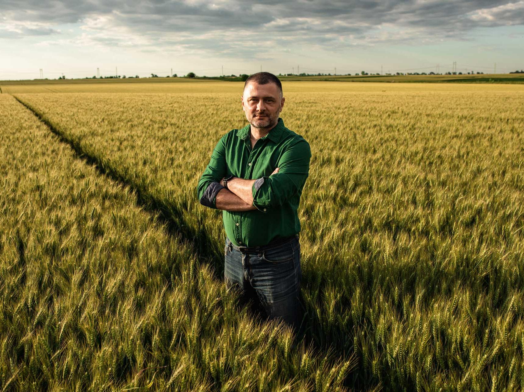 Portrait of farmer standing in wheat field
