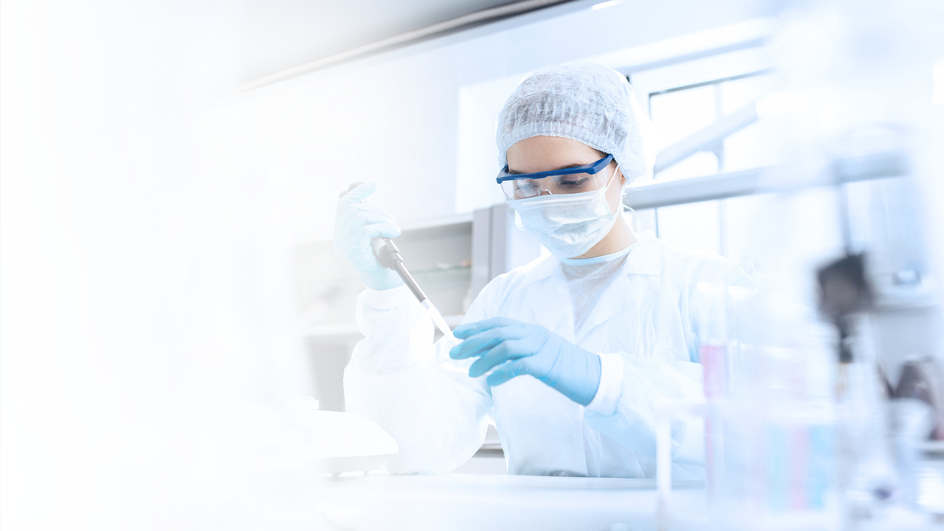 Pharma employee in the laboratory transferring liquid with a pipette