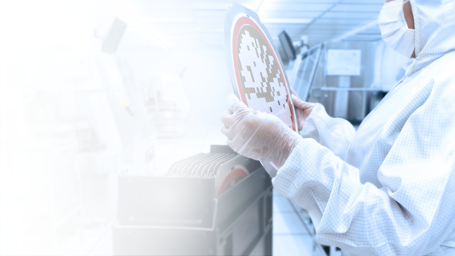 Employee in the clean room holds wafers in his hands