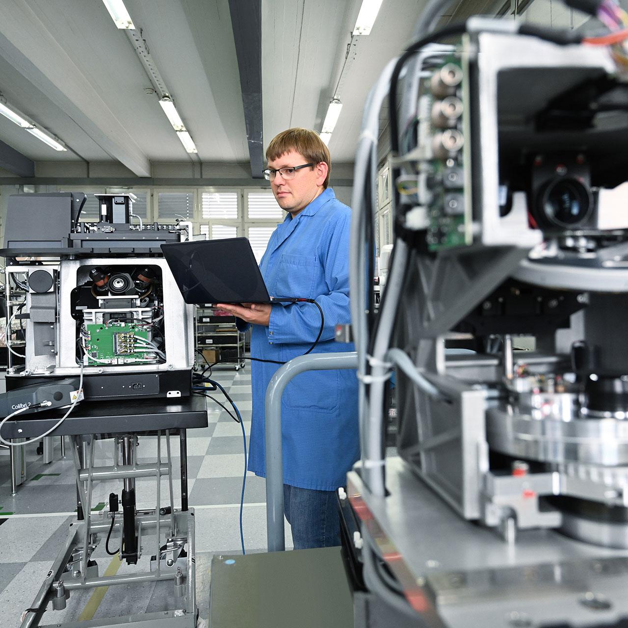 Employee checks a system with laptop