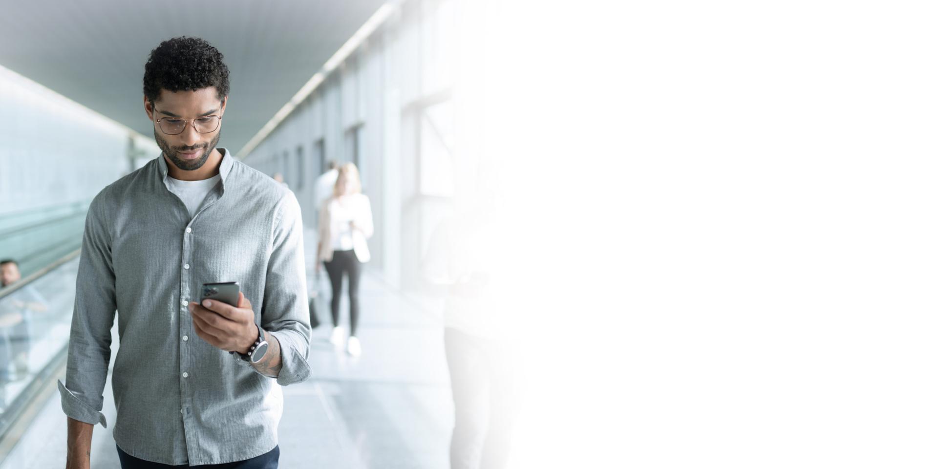 Man looking at his phone while walking