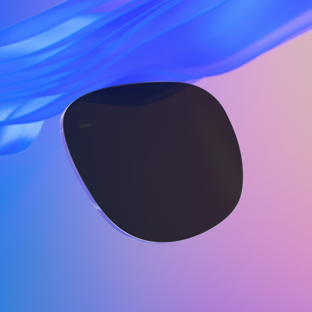 A slider image where one half shows an intensely tinted ZEISS prescription sunglass lens and one half showing the same less but less intensely tinted.