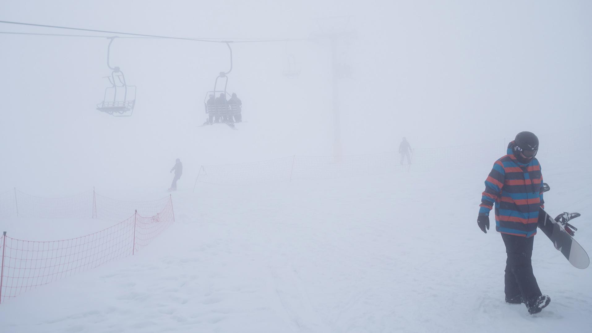 Image illustrating people skiing with mist