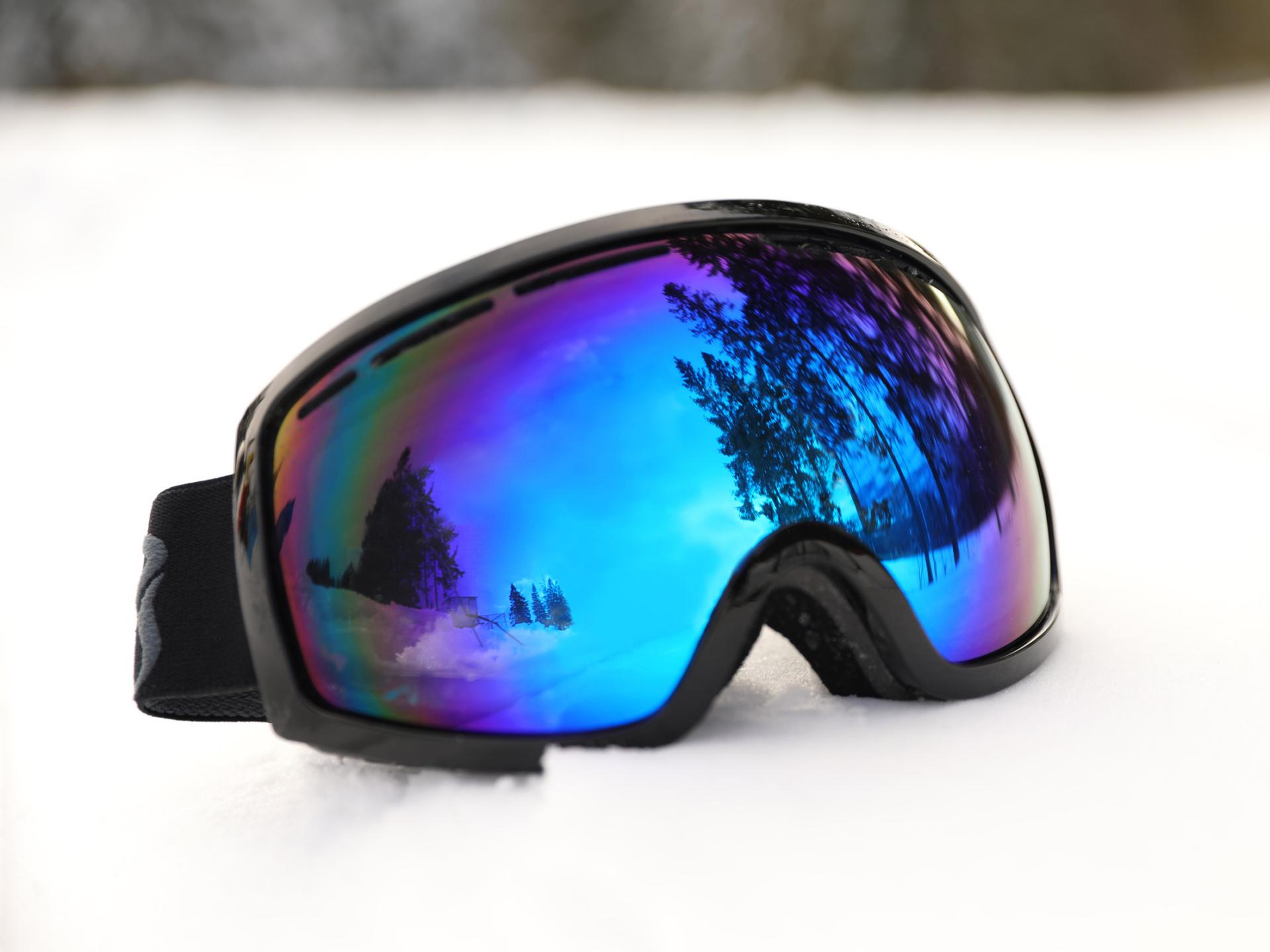 Image of a snow goggle shield in the snow.