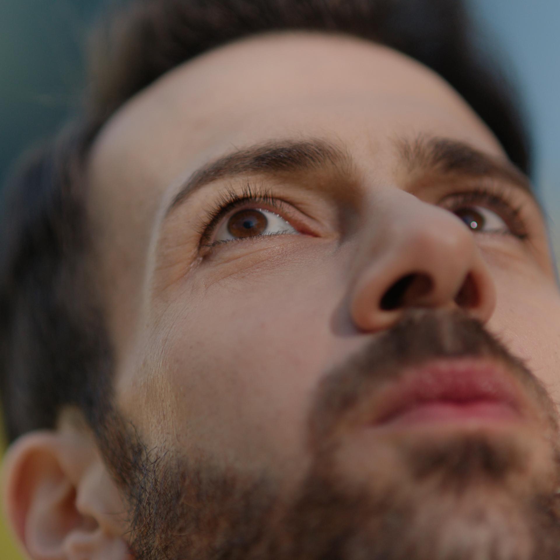 Bearded man with neutral expression symbolizing clarity, focus, and confidence after PRK eye surgery.