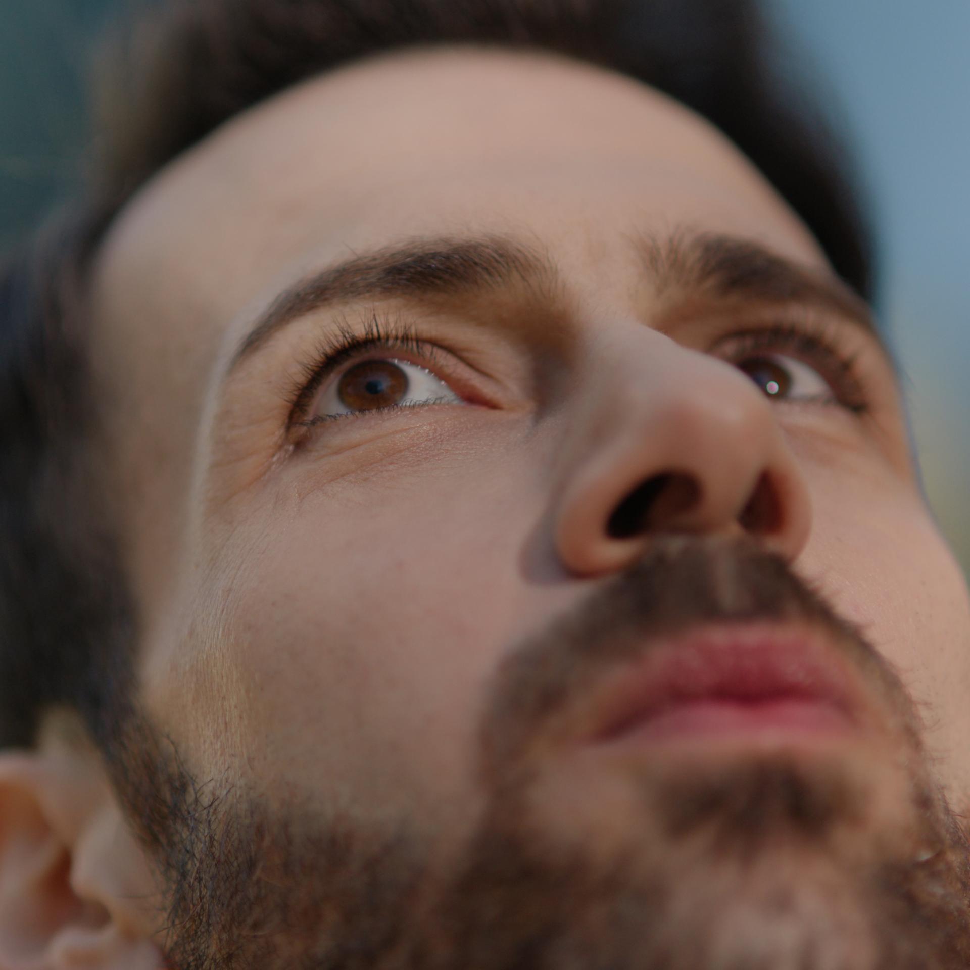 Bearded man with neutral expression symbolizing clarity, focus, and confidence after PRK eye surgery.