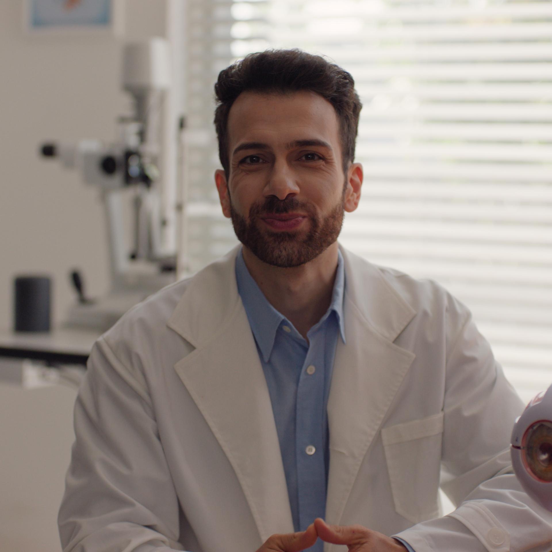 Smiling eye doctor in consultation room, representing expert advice and guidance for patients after PRK treatment.