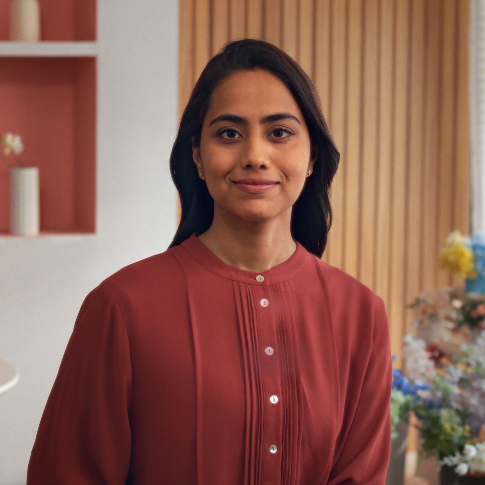 Woman standing indoors with a calm expression, representing confidence after PRK surgery.