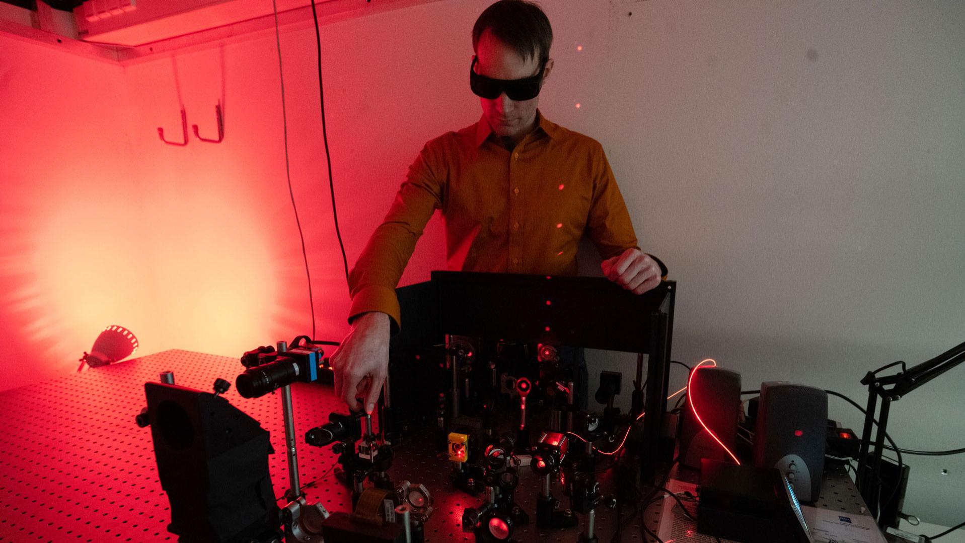 Scientist works with optical setup