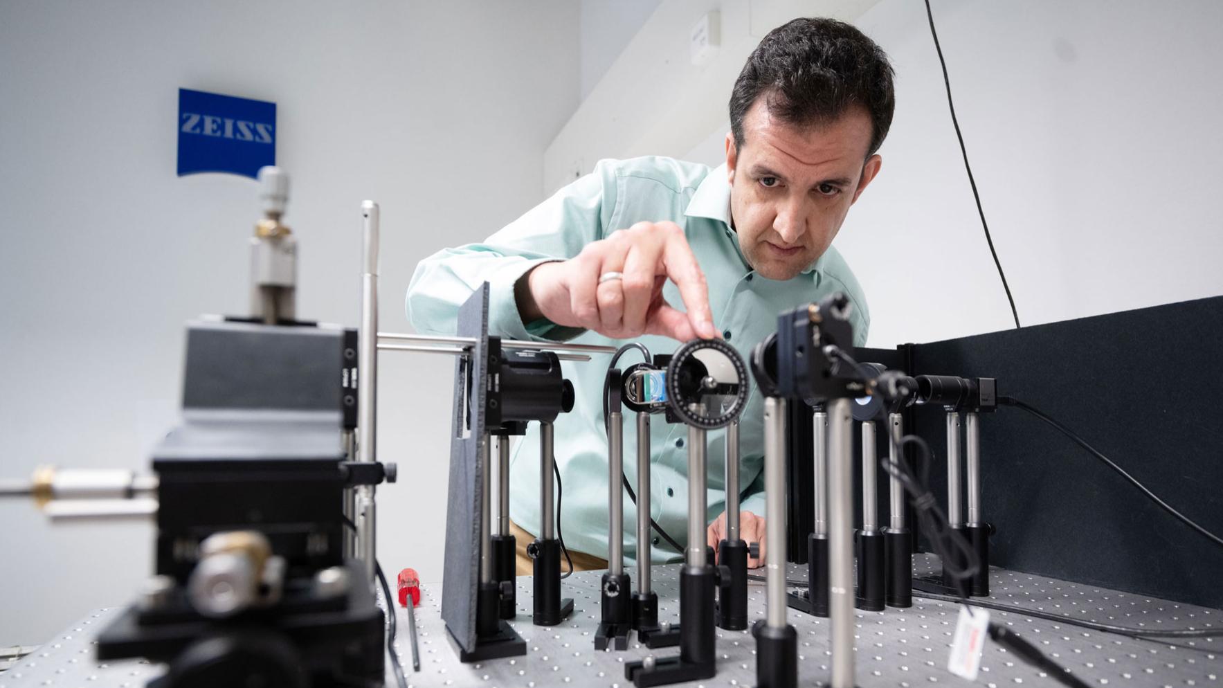 Scientist works with optical setup