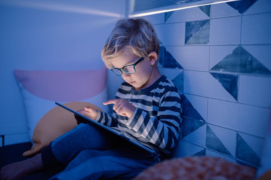 young boy playing with a tablet