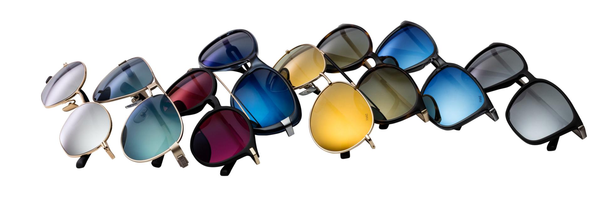 Eight sunglasses with different frames. The lenses have different mirror coatings that make them fashionable.