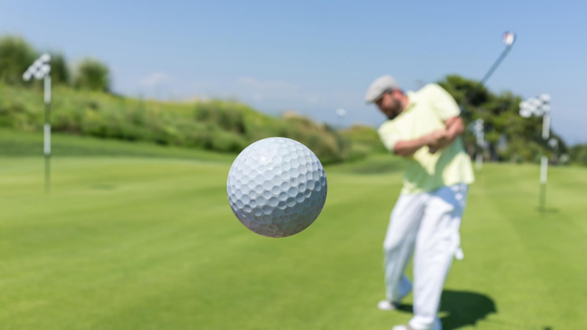 Man playing golf at club