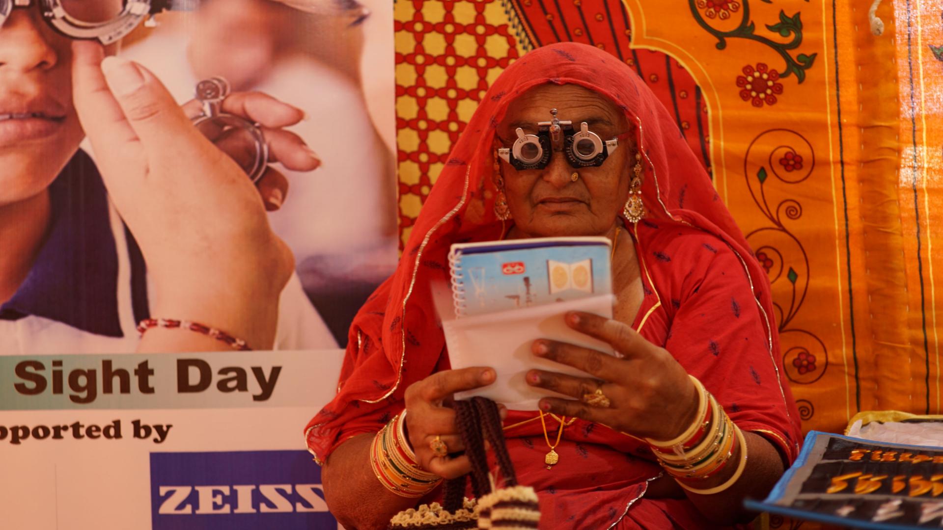 Indian women reads text with glasses.
