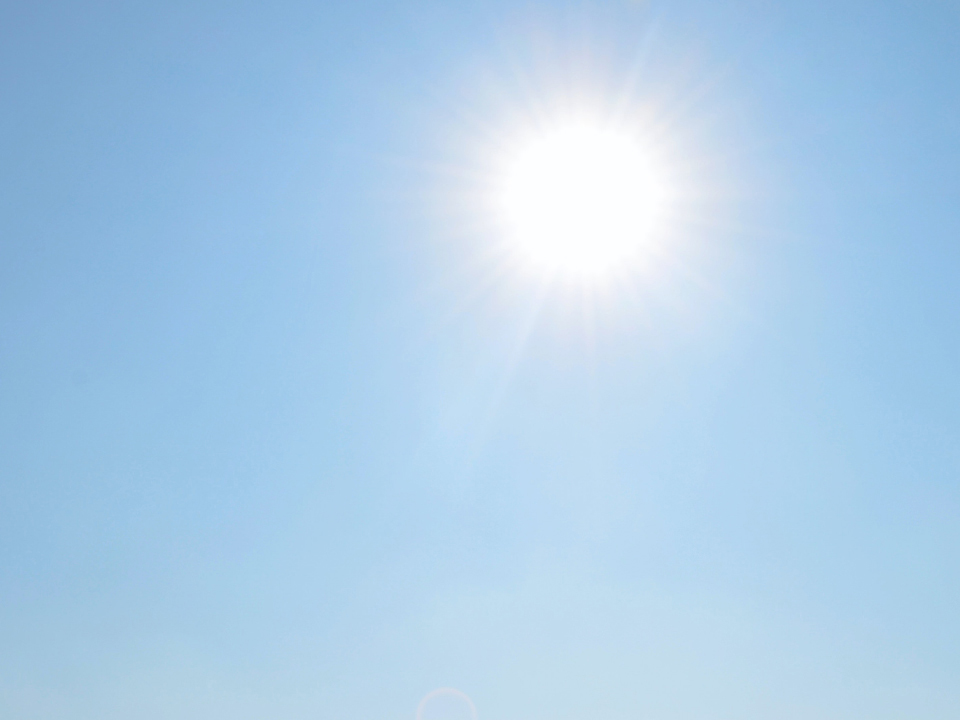 An image of the sun and blue sky. 