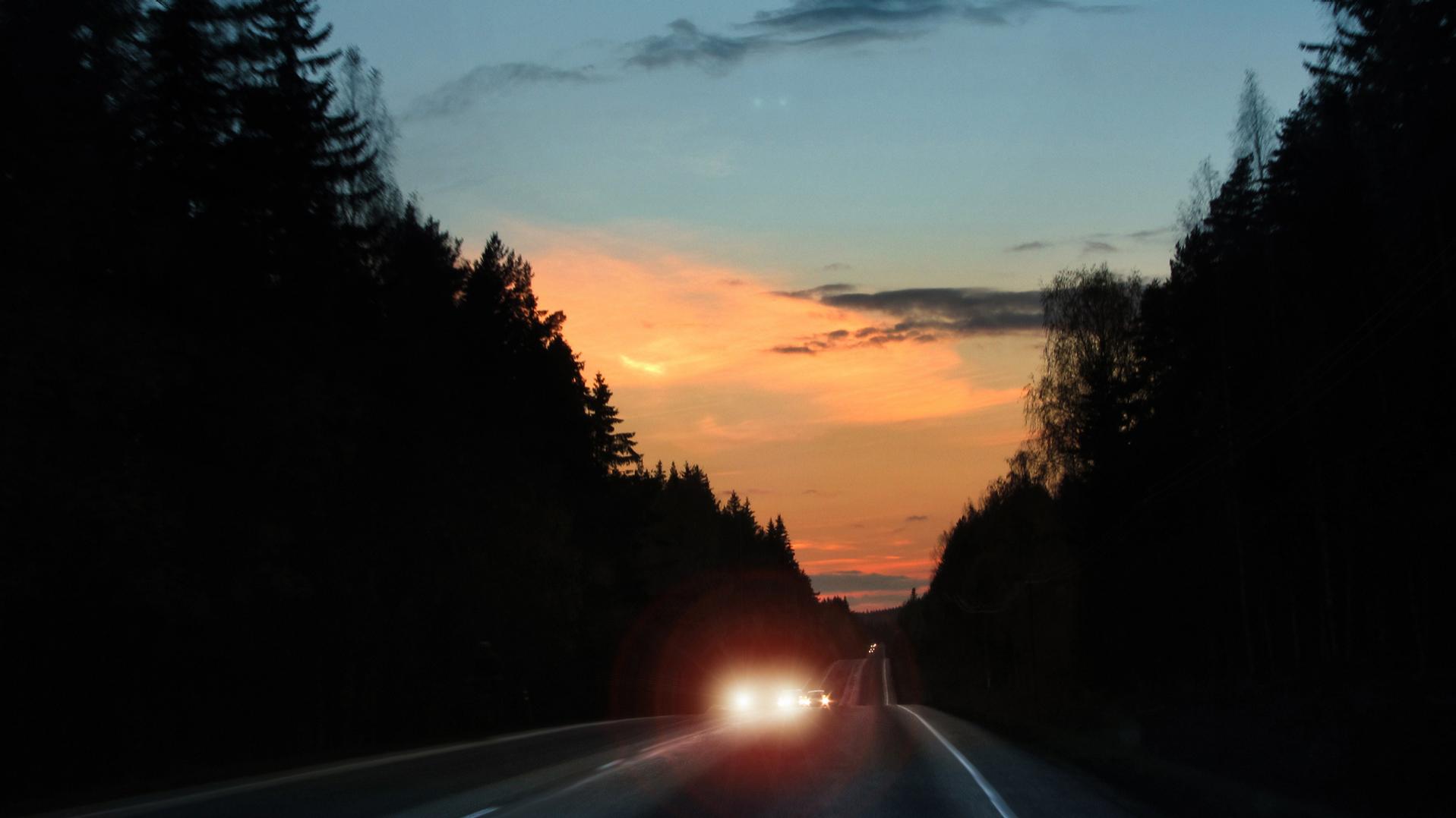 Car headlights glare in evening traffic