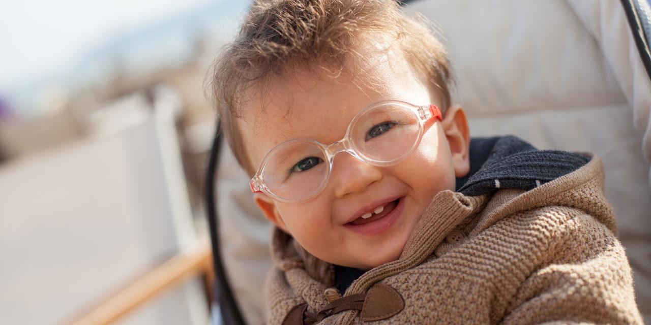 Smiling baby with eyeglasses