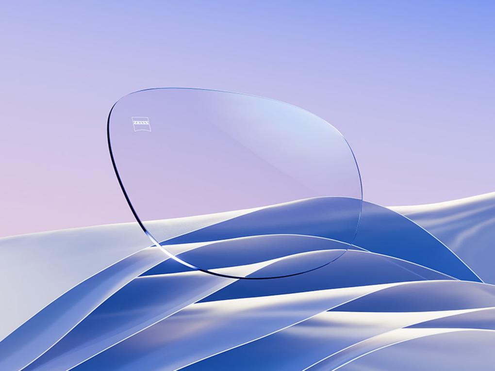 A CGI representation of a clear eyeglass lens with a subtle blue-white reflex.