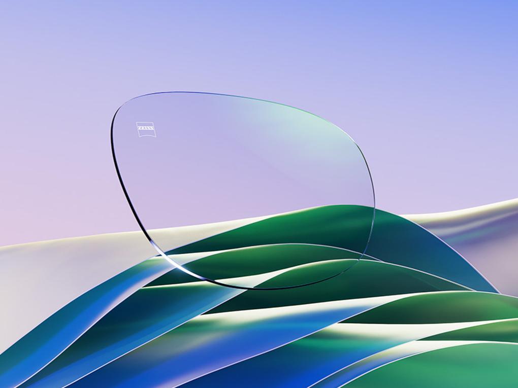 A CGI representation of a clear eyeglass lens with a subtle green reflex