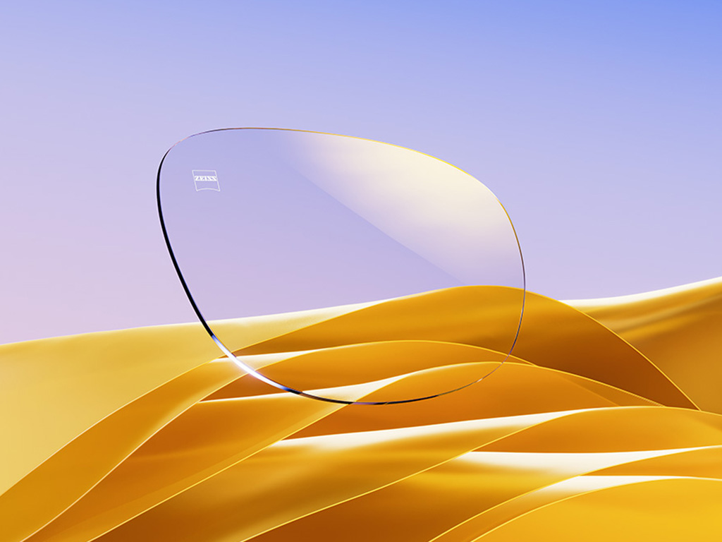 A CGI representation of a clear eyeglass lens with a subtle golden reflex.