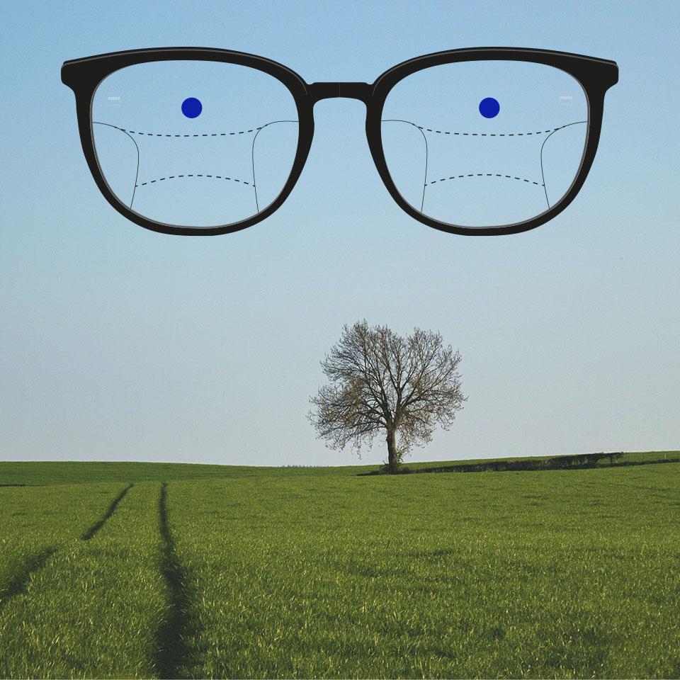 A frame with progressive lenses and schematic lines to indicate different viewing zones. Different parts of the lens are highlighted: Distance—top part of the glasses.