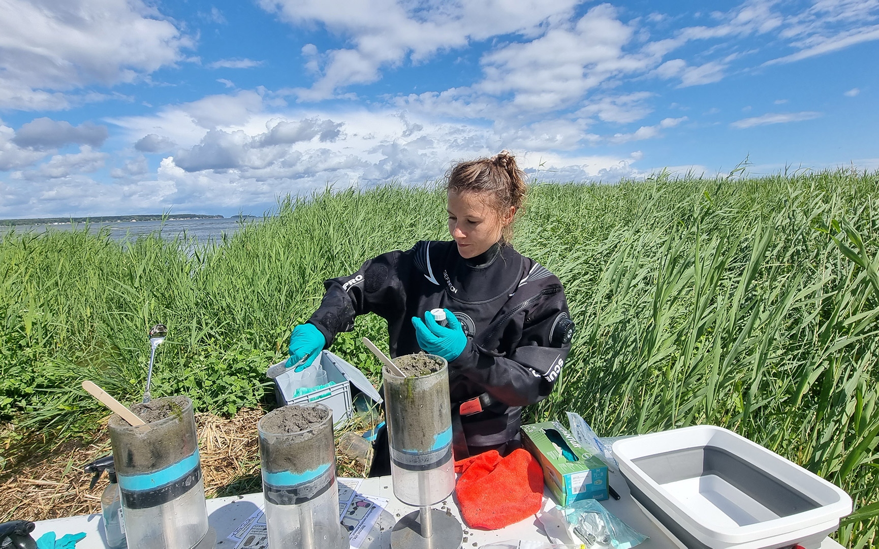 Joanna Barbara Zukowska, CBB unit research assistant/interim lab manager, collects sediment samples. Photo taken on 4 July 2023.