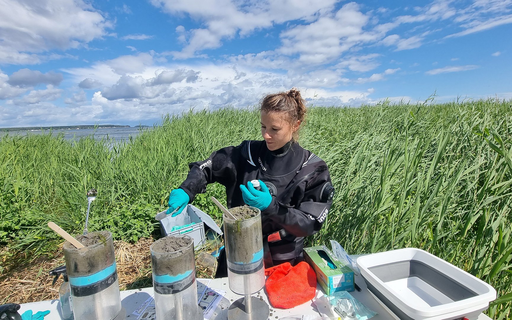 Joanna Barbara Zukowska, CBB unit research assistant/interim lab manager, collects sediment samples. Photo taken on 4 July 2023.