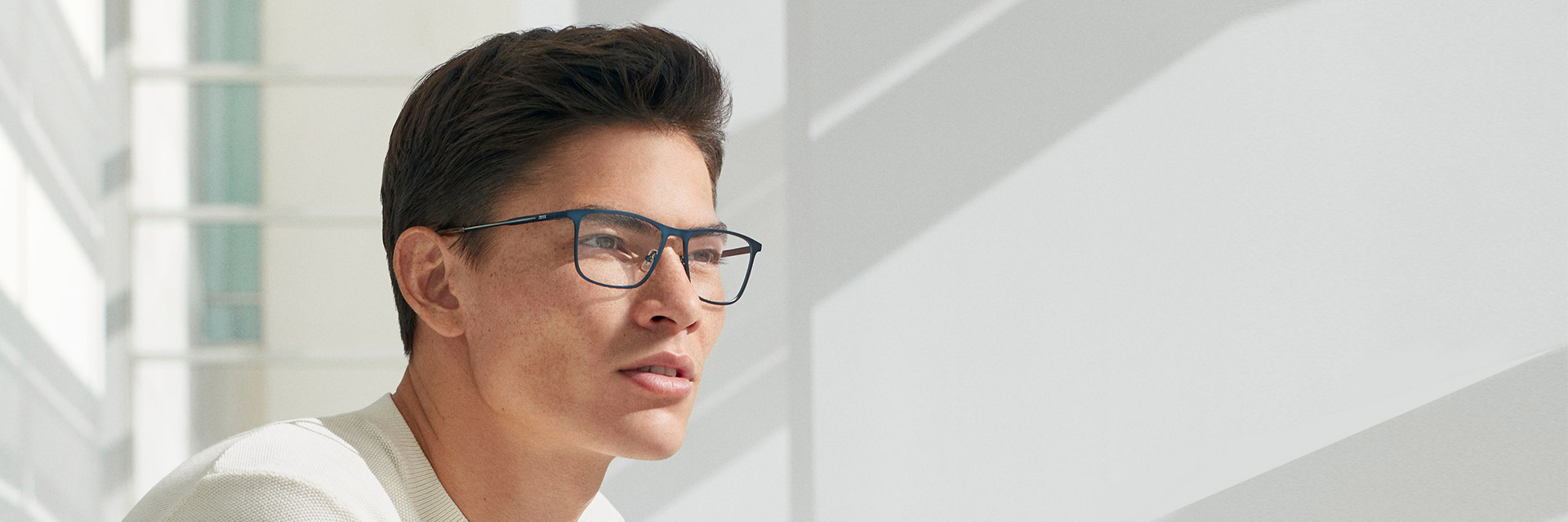 Young man wearing ZEISS eyewear by Marchon.