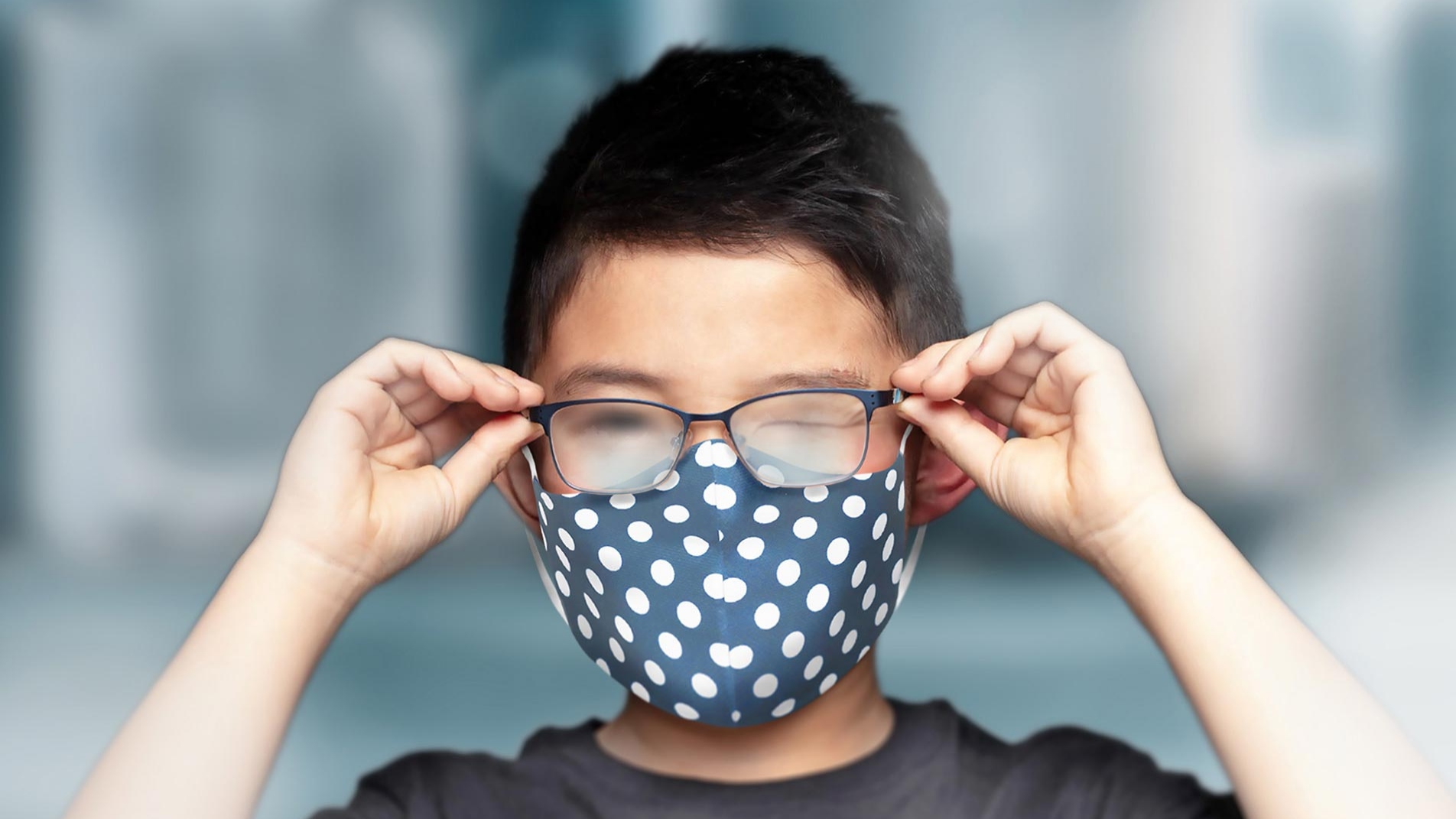 A boy wearing a mask with foggy glasses