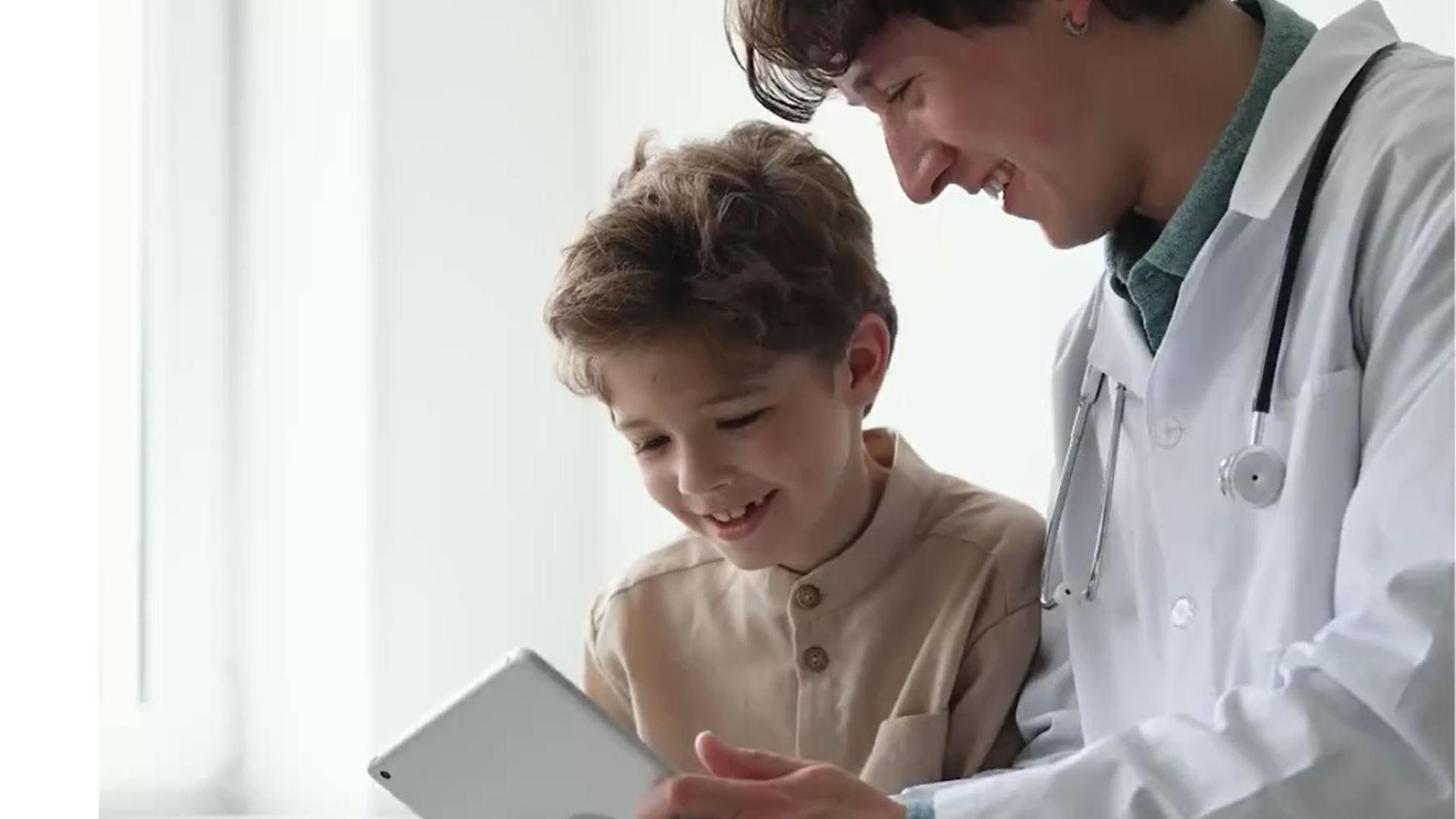 Health & Life Science Solutions - Physician sitting in front of computer screen.