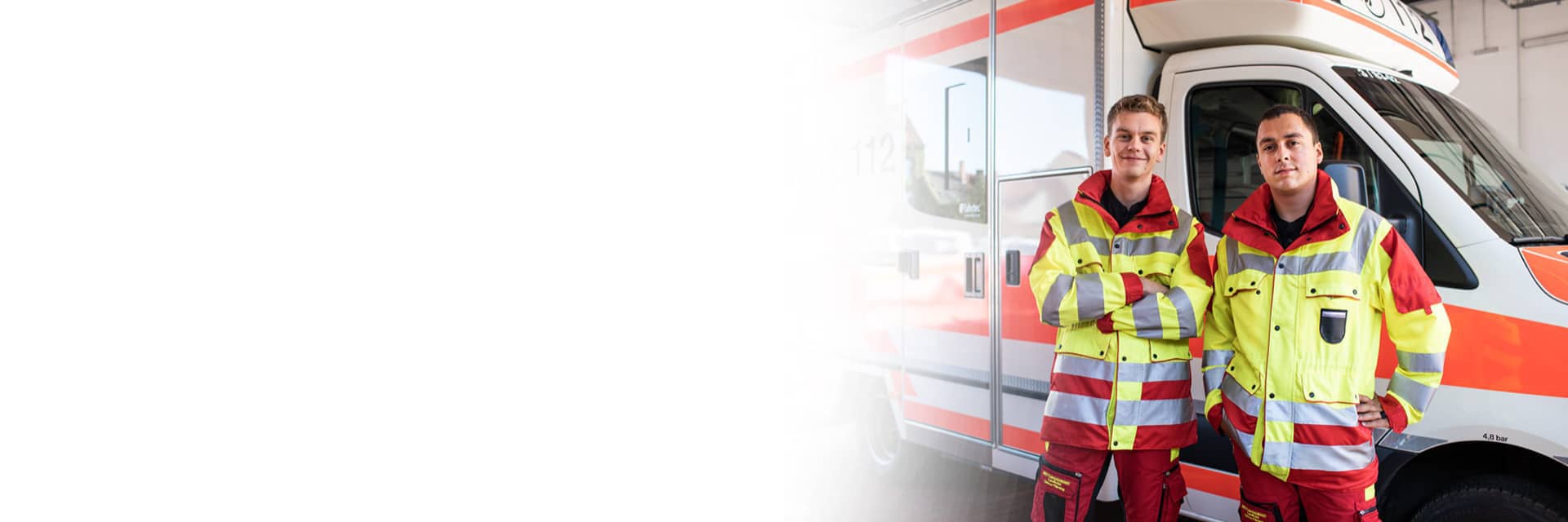Two paramedics standing in front of ambulance