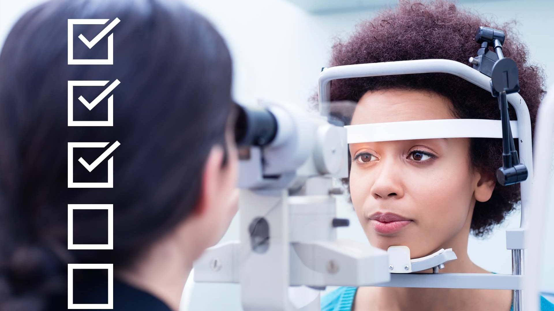 Two people test a ZEISS ophthalmic optics device